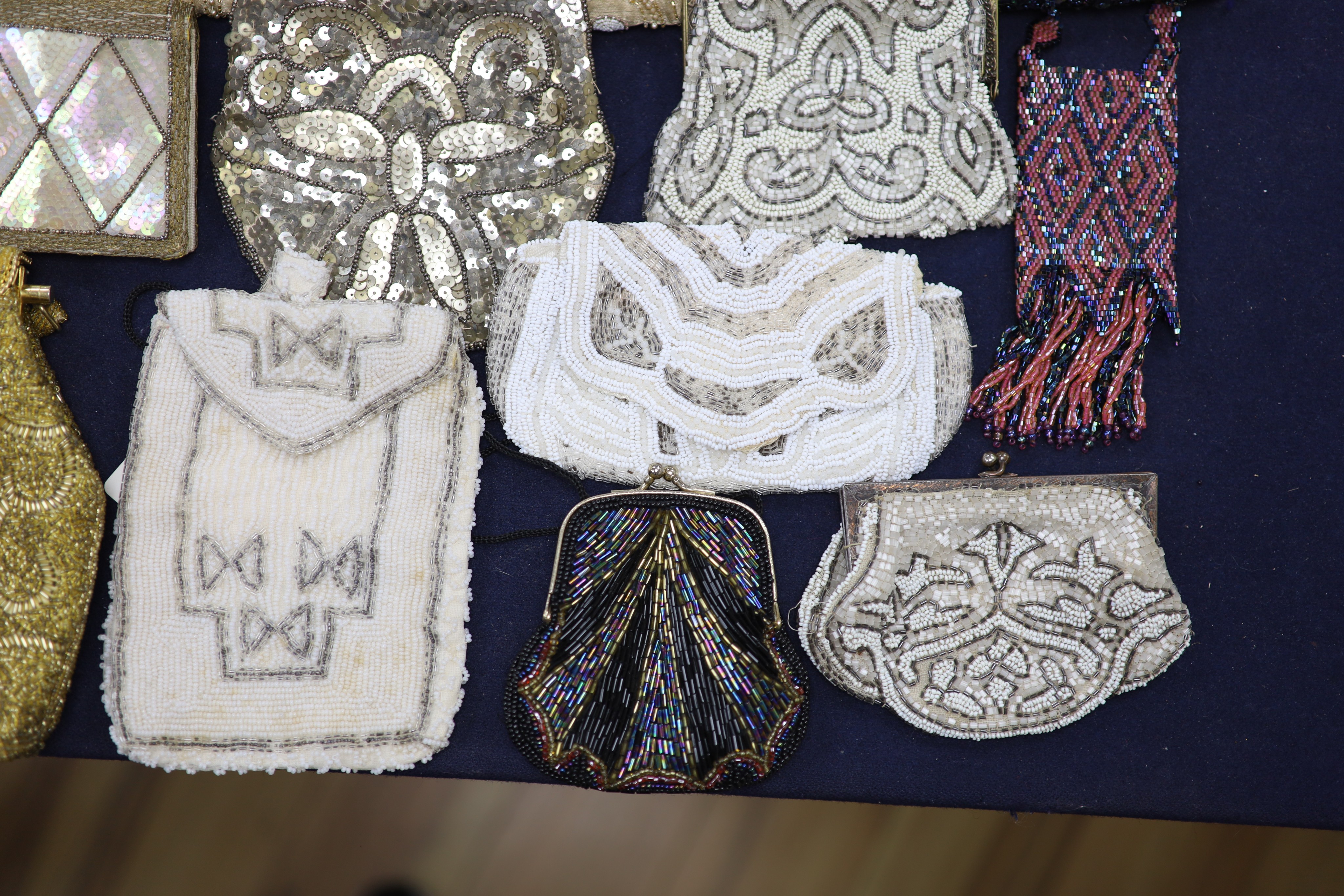 A collection of approximately fifty Victorian and later beadwork, white metal and fabric purses etc.